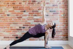 young-woman-in-yoga-position-against-exposed-brick_925x
