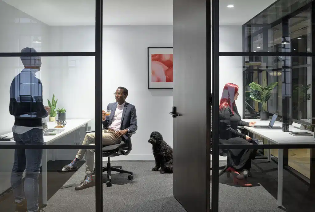 people and a dog in an office setting