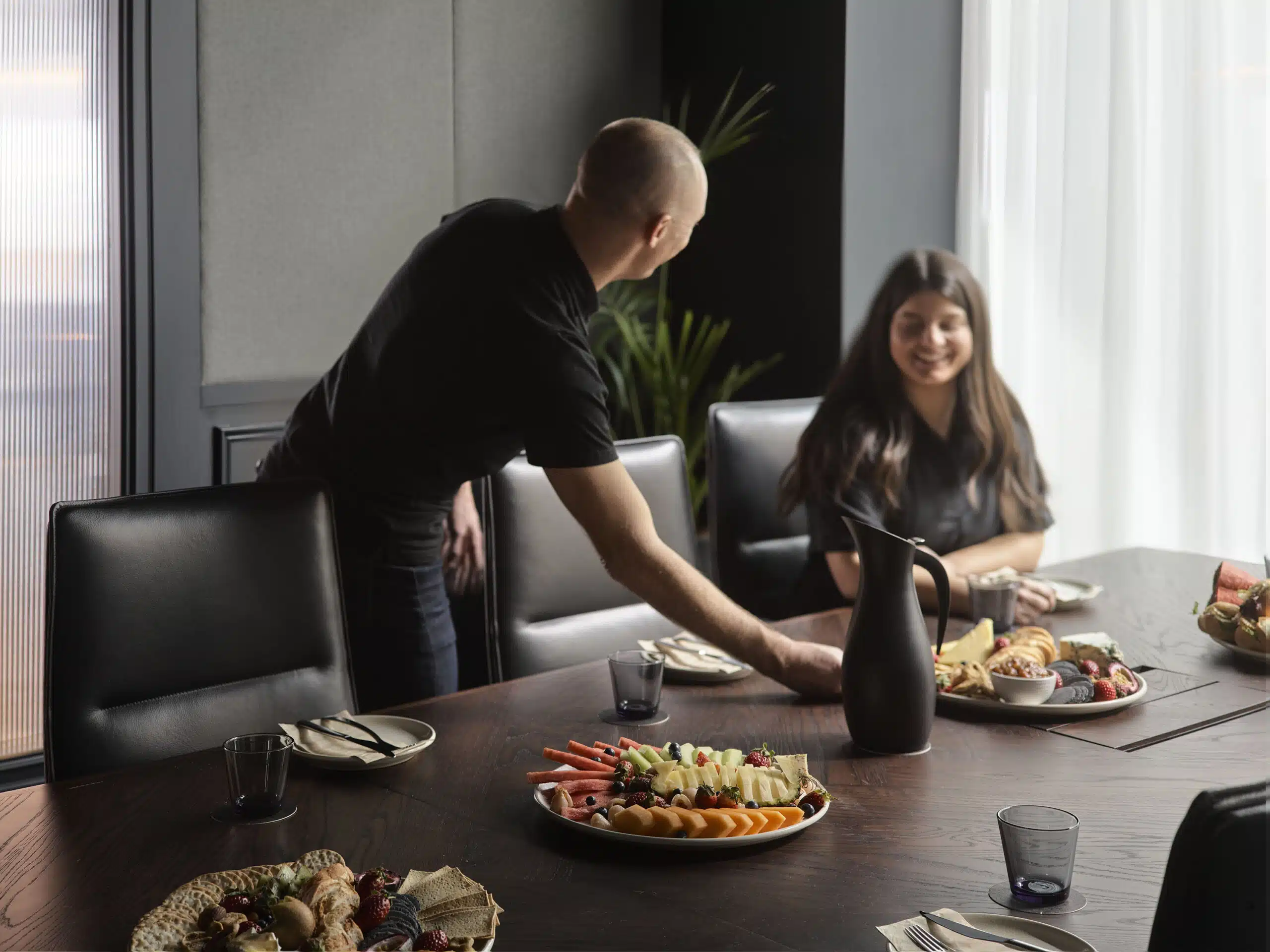 Hospitality team serving food and beverages in Hub's boardroom